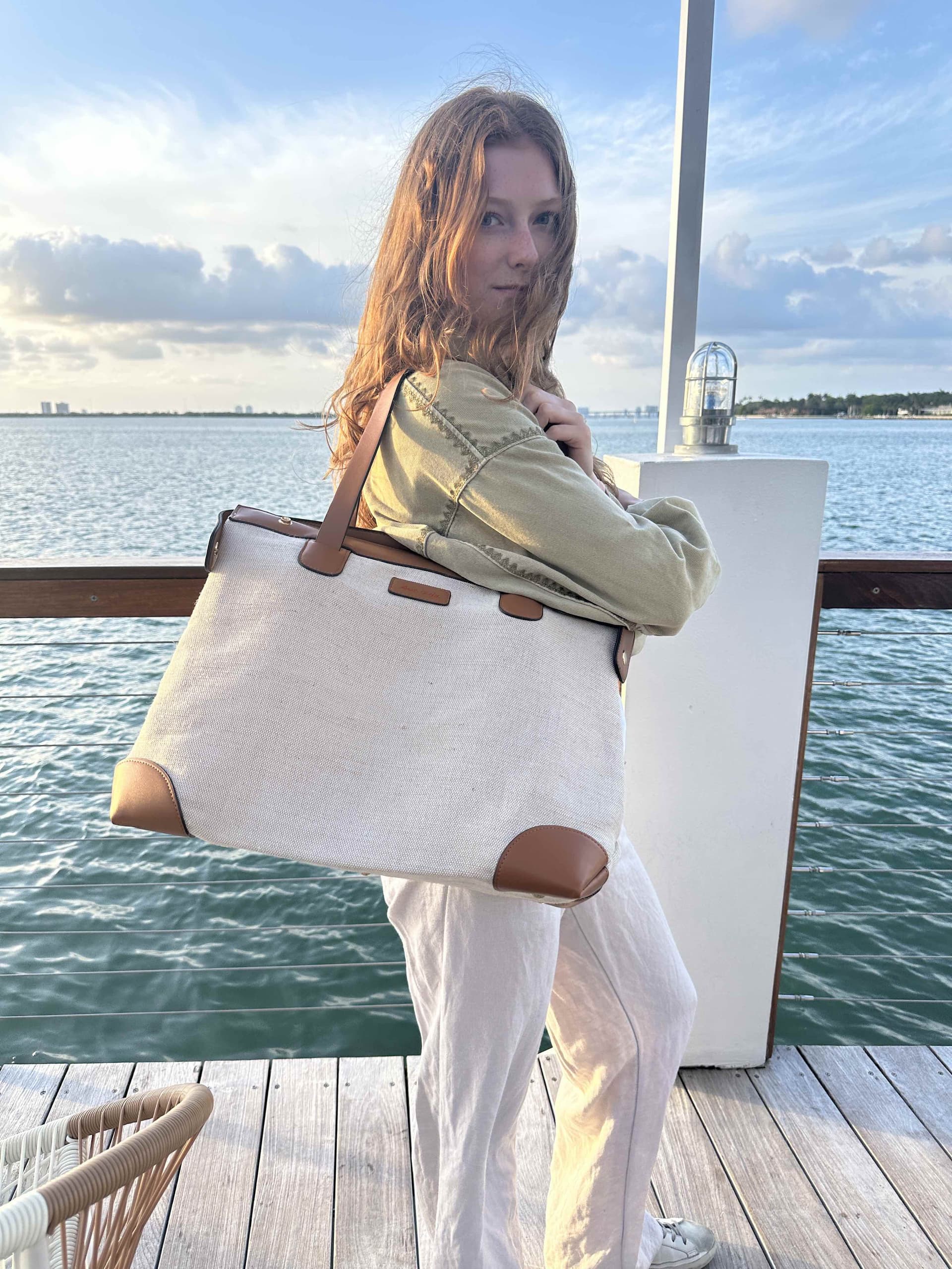 Premium linen weekender bag at dock - airline carry-on size elegant travel bag